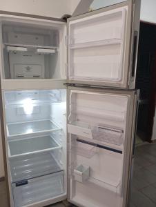 an open refrigerator with its door open and its at Apto João-de-Barro in Rondonópolis +12 photos