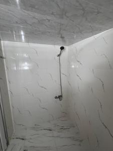 a bathroom with white marble walls and a shower at In the Forest in K'vemo Jocho +22 photos