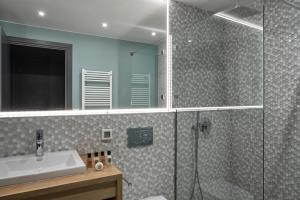 a bathroom with a glass shower and a sink at Elounda Olivia Luxury Villa Spinalonga View in Elounda +36 photos