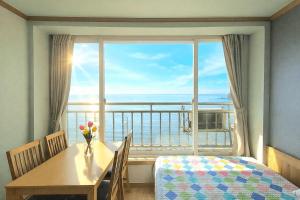 a dining room with a table and a large window at Yeongheungdo Haevichi Pension in Incheon +76 photos