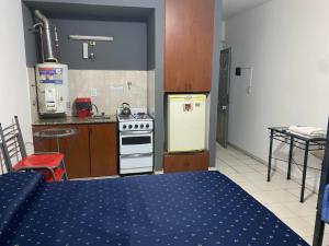 a kitchen with a stove and a refrigerator in it at Macaripana in Gualeguaychú