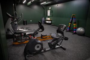 a room with a gym with a treadmill and a chair at Hotel Alexander in Mankato