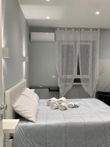 a bedroom with a bed with towels on it at Al Barone 37 in Foggia
