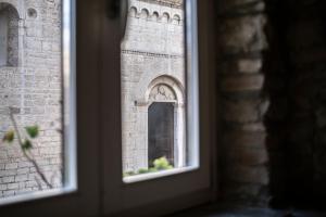 a window of a brick building with a reflection in it at La suite del convento in Potenza +5 photos