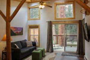 a living room with a couch and a window at Two Bridges Lodge in Bailey