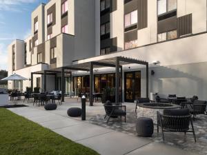 an outdoor patio with tables and chairs and a building at Fairfield by Marriott Inn & Suites Corbin in Corbin