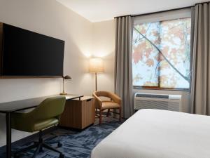a hotel room with a bed and a desk and a window at TownePlace Suites by Marriott Corbin in Corbin +27 photos
