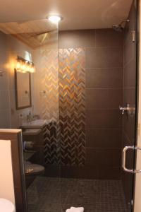 a bathroom with a shower with a glass door at Two Bridges Lodge in Bailey +62 photos