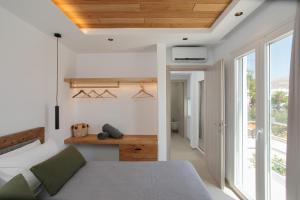 a bedroom with a bed and a large window at Amelia villas Naxos in Naxos Chora +26 photos