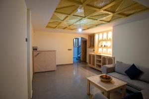 a living room with a couch and a table at Surf House Desert Point in Agadir