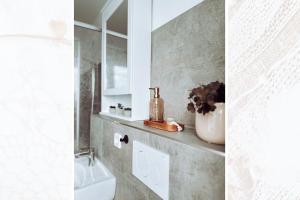 a bathroom with a sink and a toilet and a mirror at Käferhain, App 135 in Groitzsch