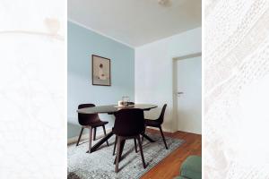 a dining room with a table and chairs at Käferhain, App 135 in Groitzsch