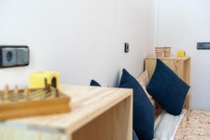 a bedroom with a bed with blue pillows at Surf House Desert Point in Agadir