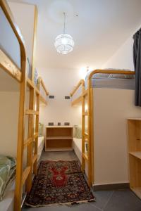 a room with two bunk beds and a rug at Surf House Desert Point in Agadir