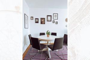 a dining room with a white table and chairs at Käferhain, App 134 in Groitzsch