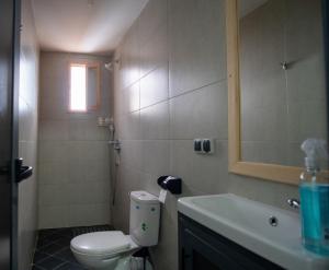 a bathroom with a toilet and a sink and a mirror at Surf House Desert Point in Agadir +60 photos