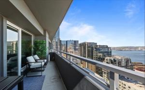 a balcony with a view of a city at Luxury, ocean view Condo with deck and indoor pool in Seattle