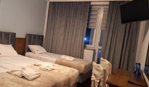 a hotel room with two beds and a window at Motel Jaśminowy Dworek Człekówka 67 B in Człekowka