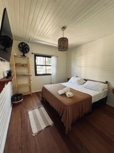 a bedroom with a large bed in a room at Ar do Mar in Florianópolis