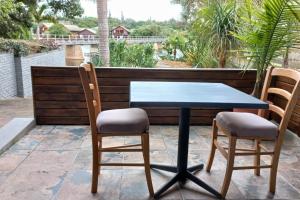 a blue table and two chairs on a patio at RiverBanks in Wilderness