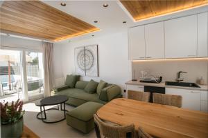 a kitchen and living room with a couch and a table at Amelia villas Naxos in Naxos Chora