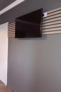 a flat screen tv hanging on a wall at RiverBanks in Wilderness