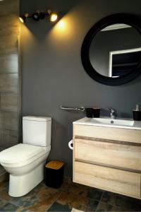 a bathroom with a toilet and a sink and a mirror at RiverBanks in Wilderness +61 photos