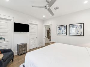 a white bedroom with a bed and a couch at CaSEAta by 30A Escapes in Rosemary Beach +29 photos
