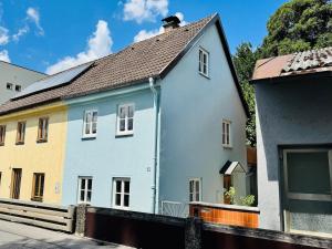 ein blau-weißes Haus neben einem Gebäude in der Unterkunft TheBlueInn in Wasserburg am Inn