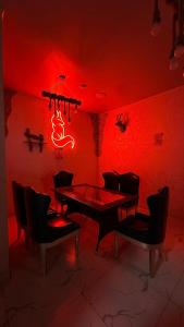 a red room with a dining room table and chairs at Klass in Taraz