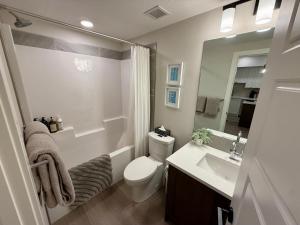 a bathroom with a toilet and a sink and a mirror at Sparrowhawk Mountain Resort in Dead Man's Flats +24 photos