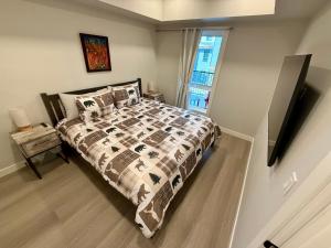 a bedroom with a bed with a comforter and a window at Sparrowhawk Mountain Resort in Dead Man's Flats