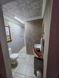 a bathroom with a toilet and a sink at Best View. in Burgersfort