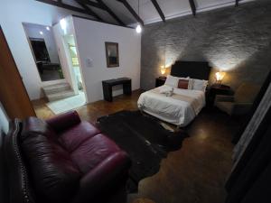 a bedroom with a bed and a couch in a room at Best View. in Burgersfort