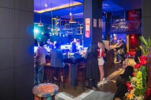a group of people standing around a bar at Martí in La Paz