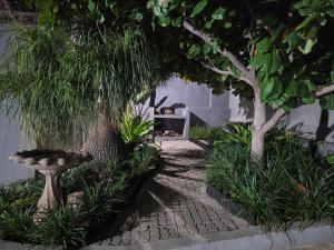 a garden with trees and a stone walkway at Best View. in Burgersfort