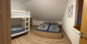 a small room with two bunk beds in it at Apartmány TAS in Jablonec nad Jizerou