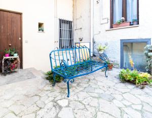 a blue bench sitting on a stone patio at La Cantina del Convento in Potenza