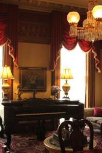 a living room with a piano and a couch at Upjohn in Kalamazoo