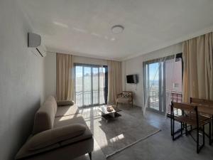 a living room with a couch and a table at Maia Suites in Çeşme