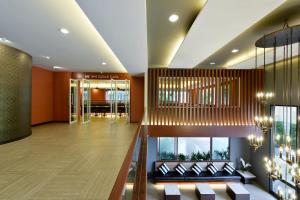a lobby with a couch and a dining room at Hisea Huahin Hotel in Hua Hin +30 photos