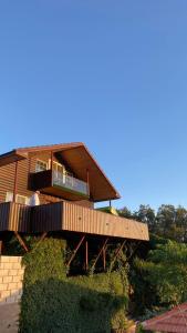 a man standing on a wooden deck in front of a house at North Jewel 2023 in Ajloun