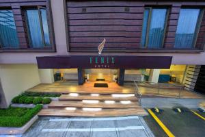 a hotel entrance with a sign for a family hotel at Fenix Hotel in Quito