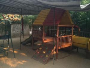 a playground with a gazebo and a slide at Tetas Villa in Naj‘ al Maḩaţţah