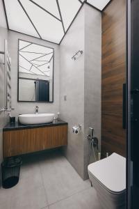 a bathroom with a sink and a mirror and a toilet at Avant Park GK Aparts in Baku +17 photos