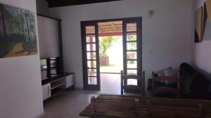 a living room with a door open to a patio at Casas Adilio Florianopolis-norte in Florianópolis