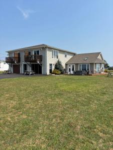 a large house with a lawn in front of it at PEI Cottage Rental in Borden-Carleton