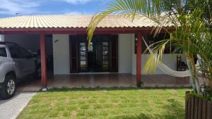 a house with a car parked in front of it at Casas Adilio Florianopolis-norte in Florianópolis