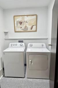 a kitchen with white appliances and a painting on the wall at 4th Street Residences in Saint David