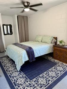 a bedroom with a bed and a ceiling fan at 4th Street Residences in Saint David +8 photos